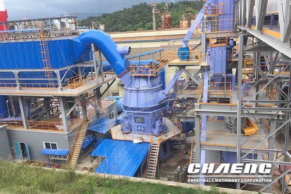 How does the vertical roller mill achieve grinding?